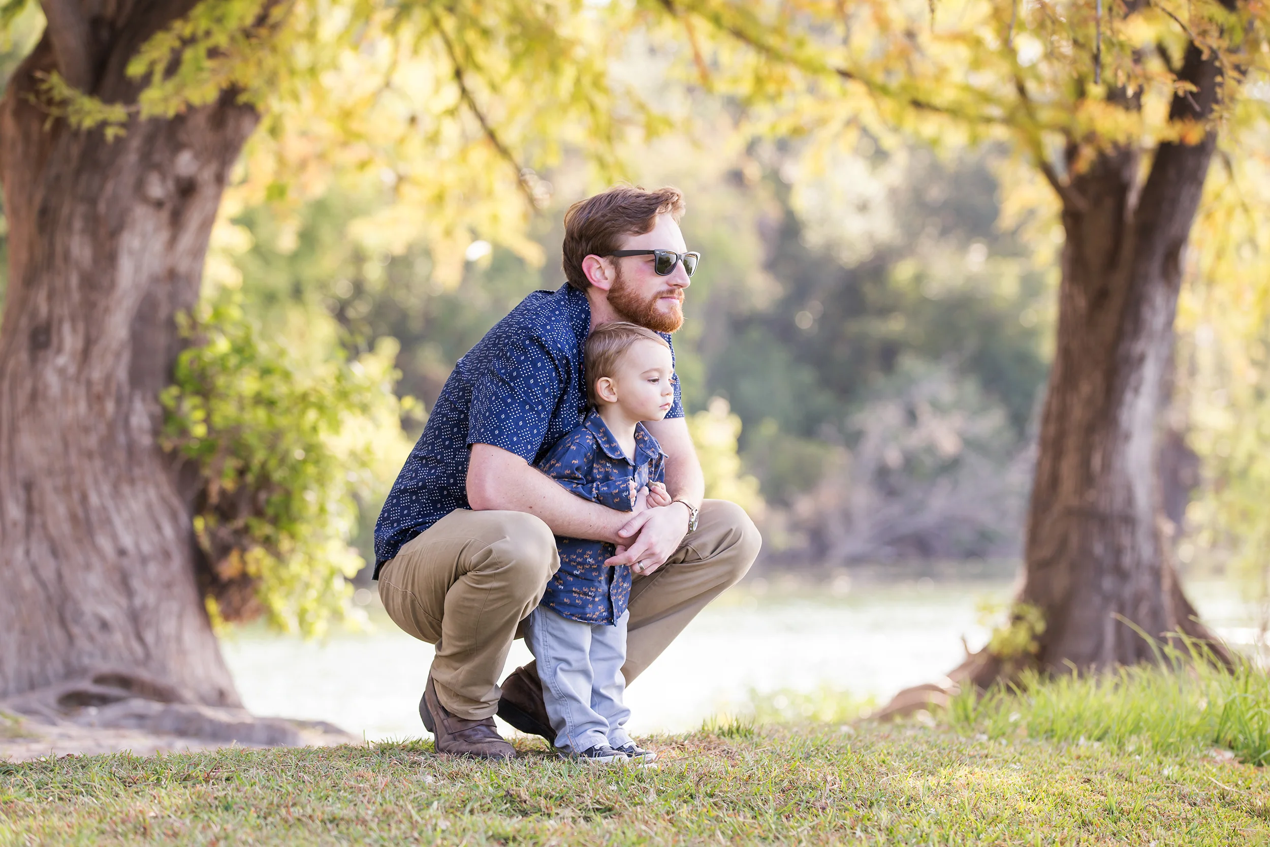 Father-toddler-son-hugging-river-park.jpg