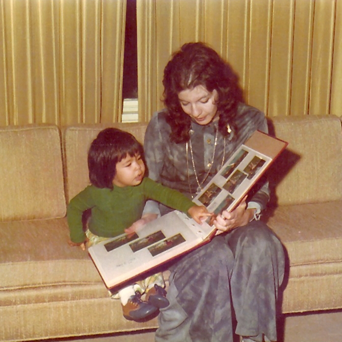 Mom dressed to go out, showing me baby pictures before the babysitter came.