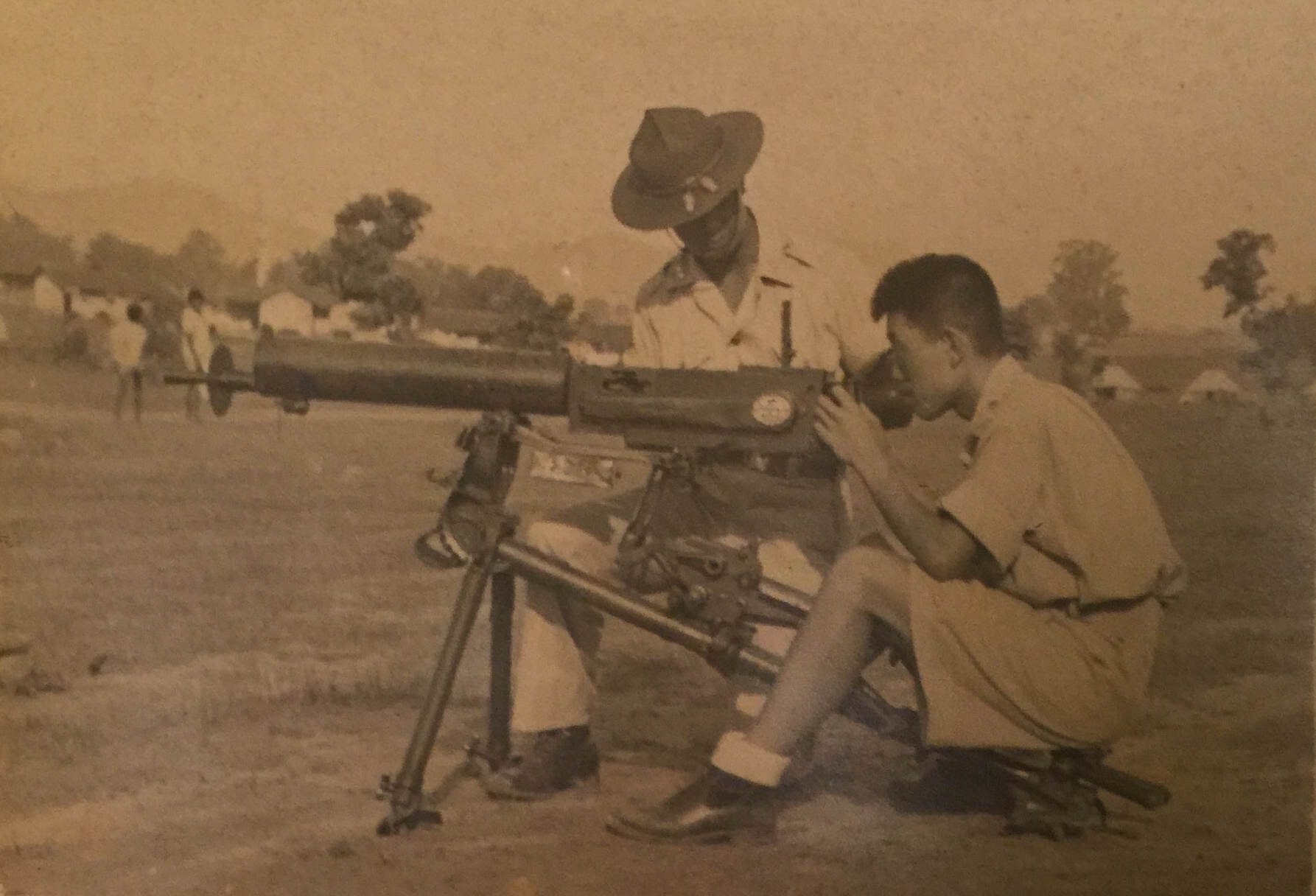Dad trains a Chinese soldier on a seized Japanese weapon at Ramgarh 1943. If you look closely, you can see a German Swastika on the side.