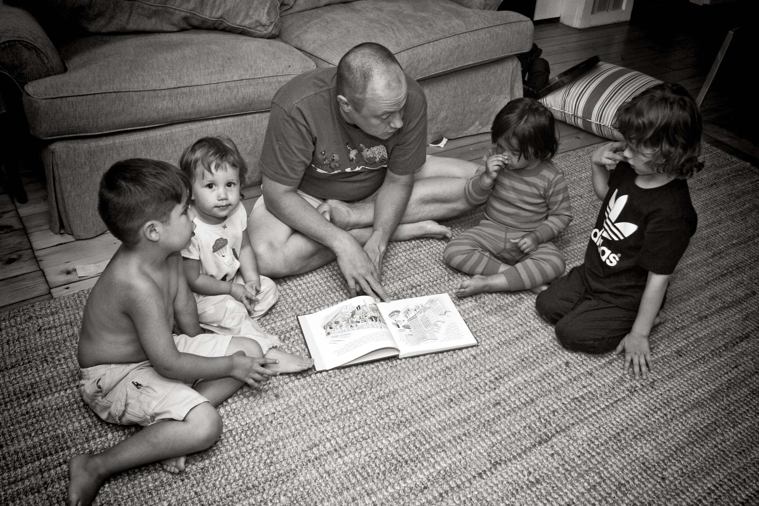 The oldest grandchild (Michael) reads to the youngest.