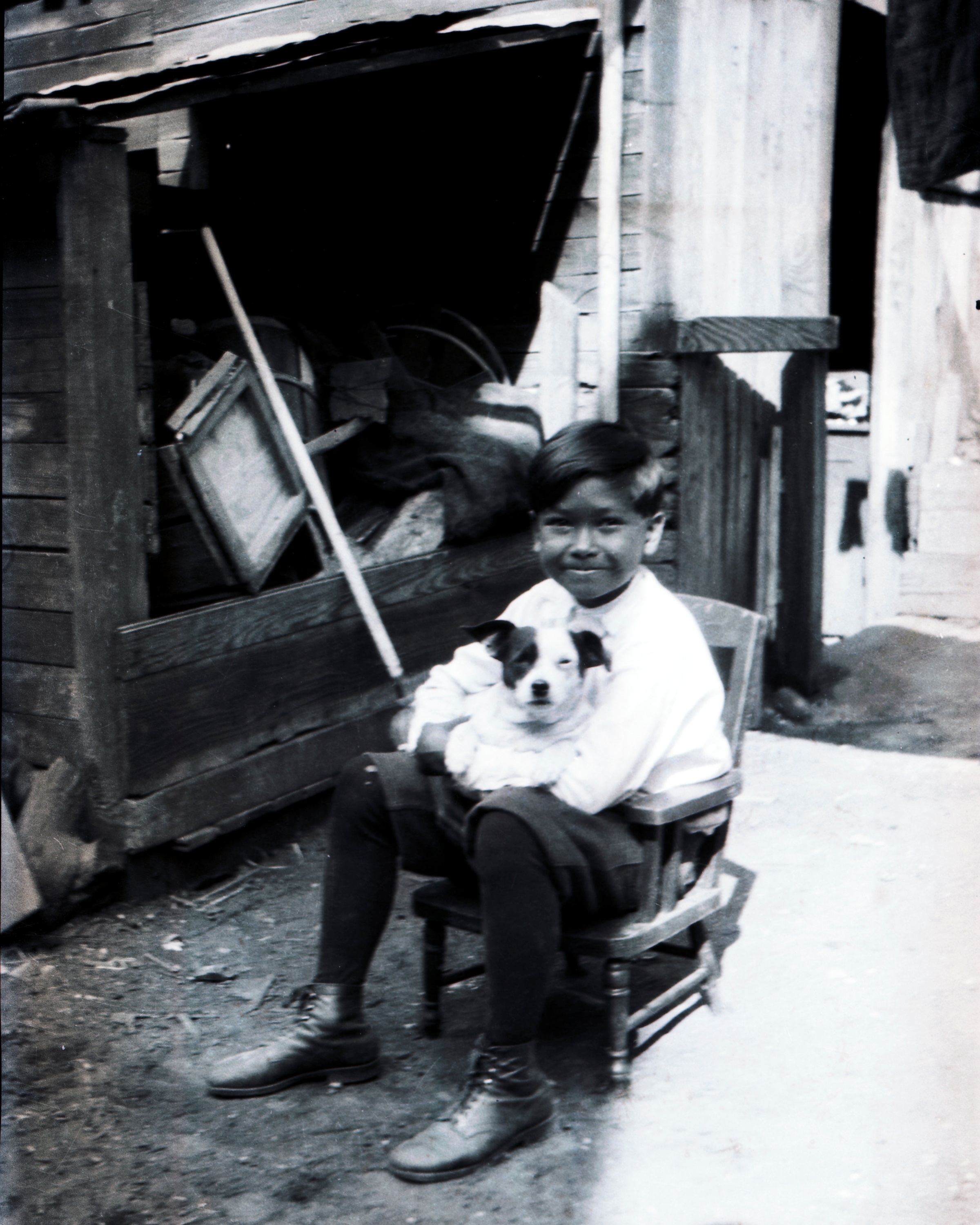 Me and Tricky, sitting in "the chair" that Charley liked to tell about, in the walled courtyard behind our laundry.