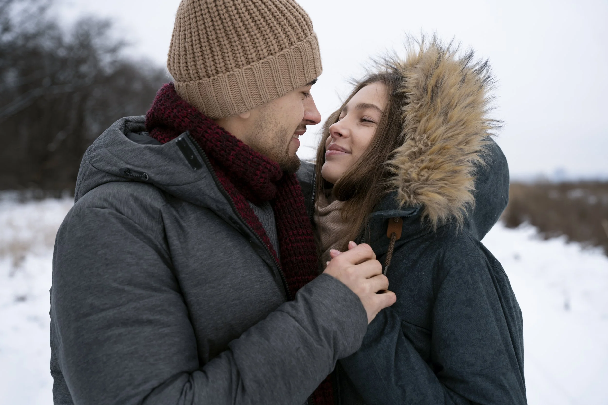 Couple sharing a warm, connected moment outdoors in winter, reflecting emotional intimacy and communication often supported in couples therapy across Ontario