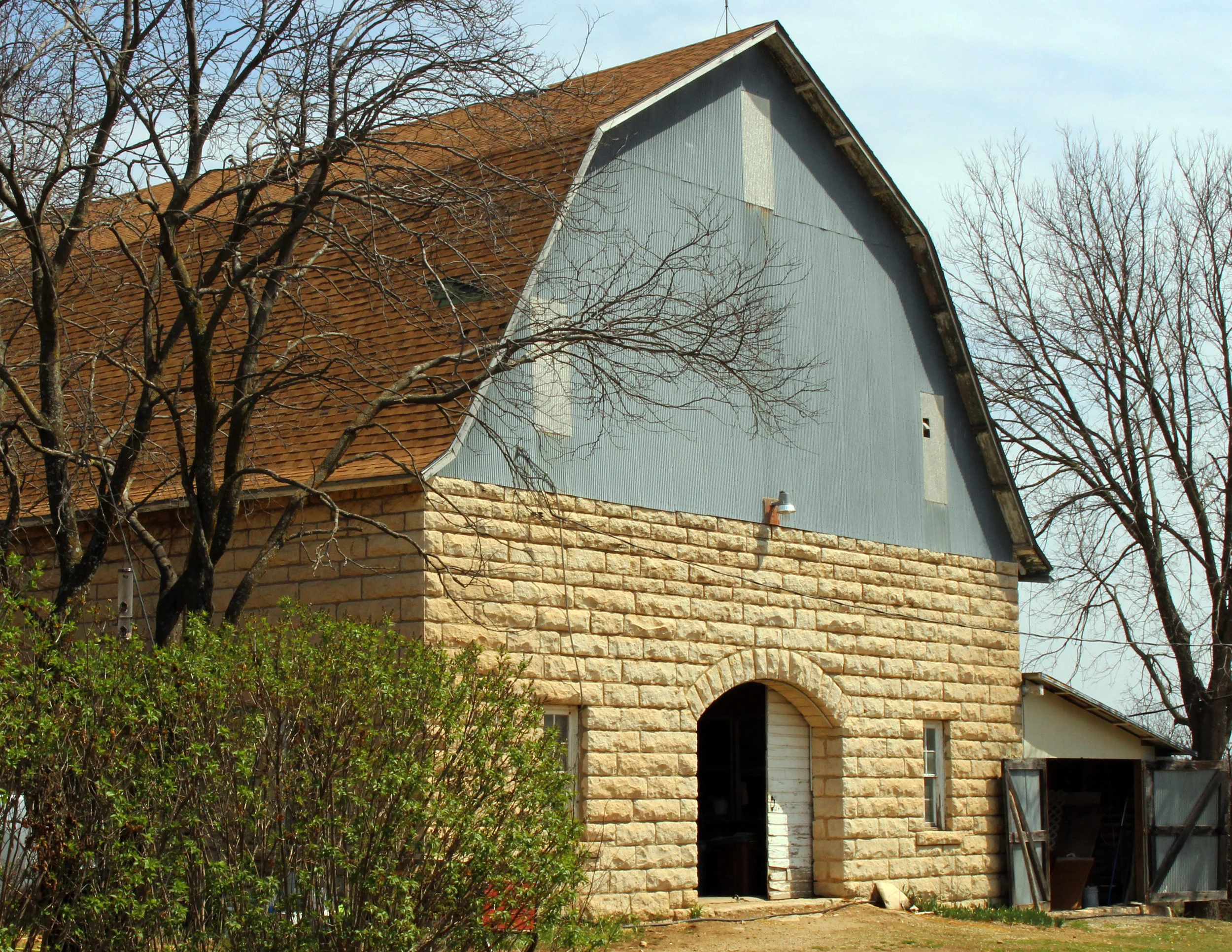 Stone barn through trees.jpg