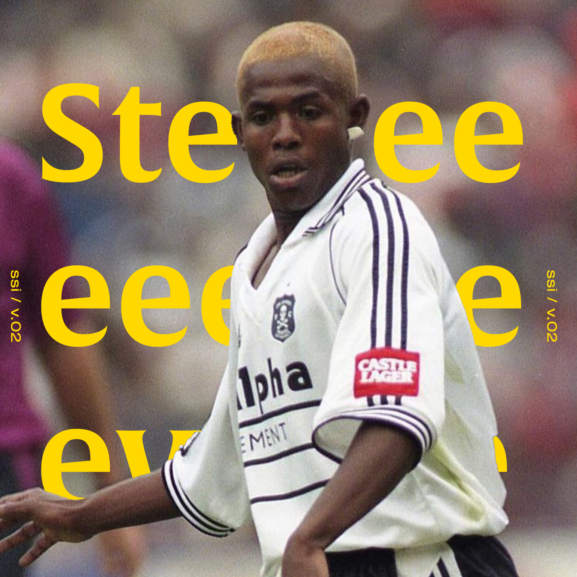 A male soccer player with bleached blonde hair wearing a white jersey with purple stripes and sponsorship logos, on a soccer field with a blurred background.