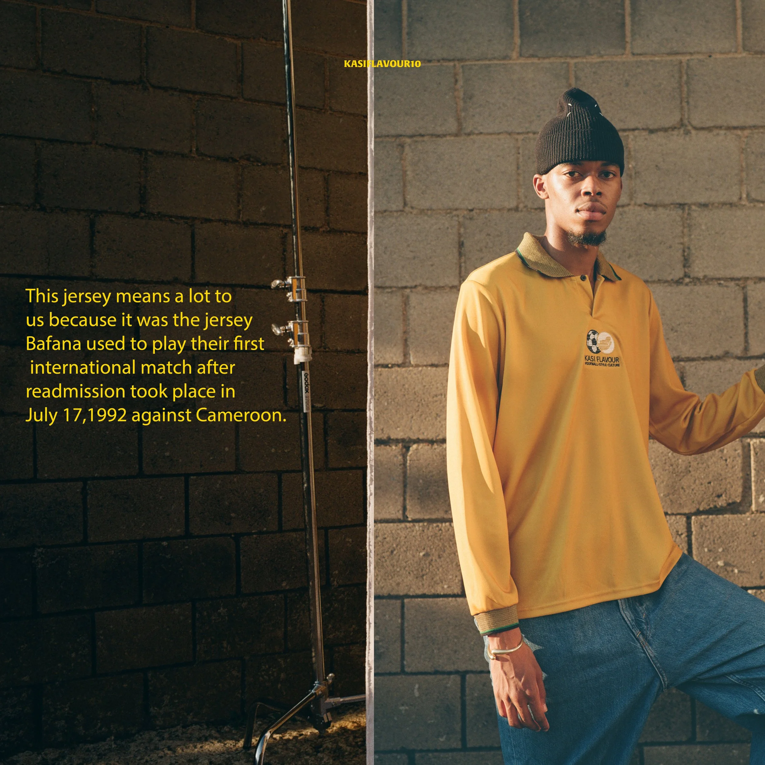 A young man wearing a yellow jersey stands against a brick wall, with a spotlight and a microphone stand beside him. The left side of the image features text explaining that the jersey is from the 1992 match between Bafana Bafana and Cameroon.