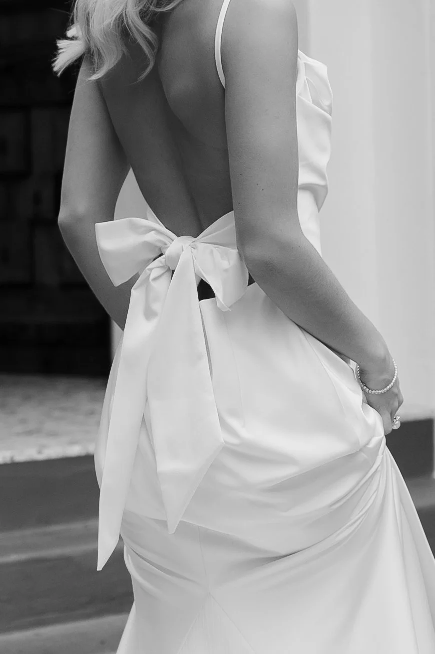 The bow on the back of a bride's dress, in black and white