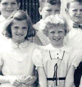 Two little girls laughing until someone told us to stop