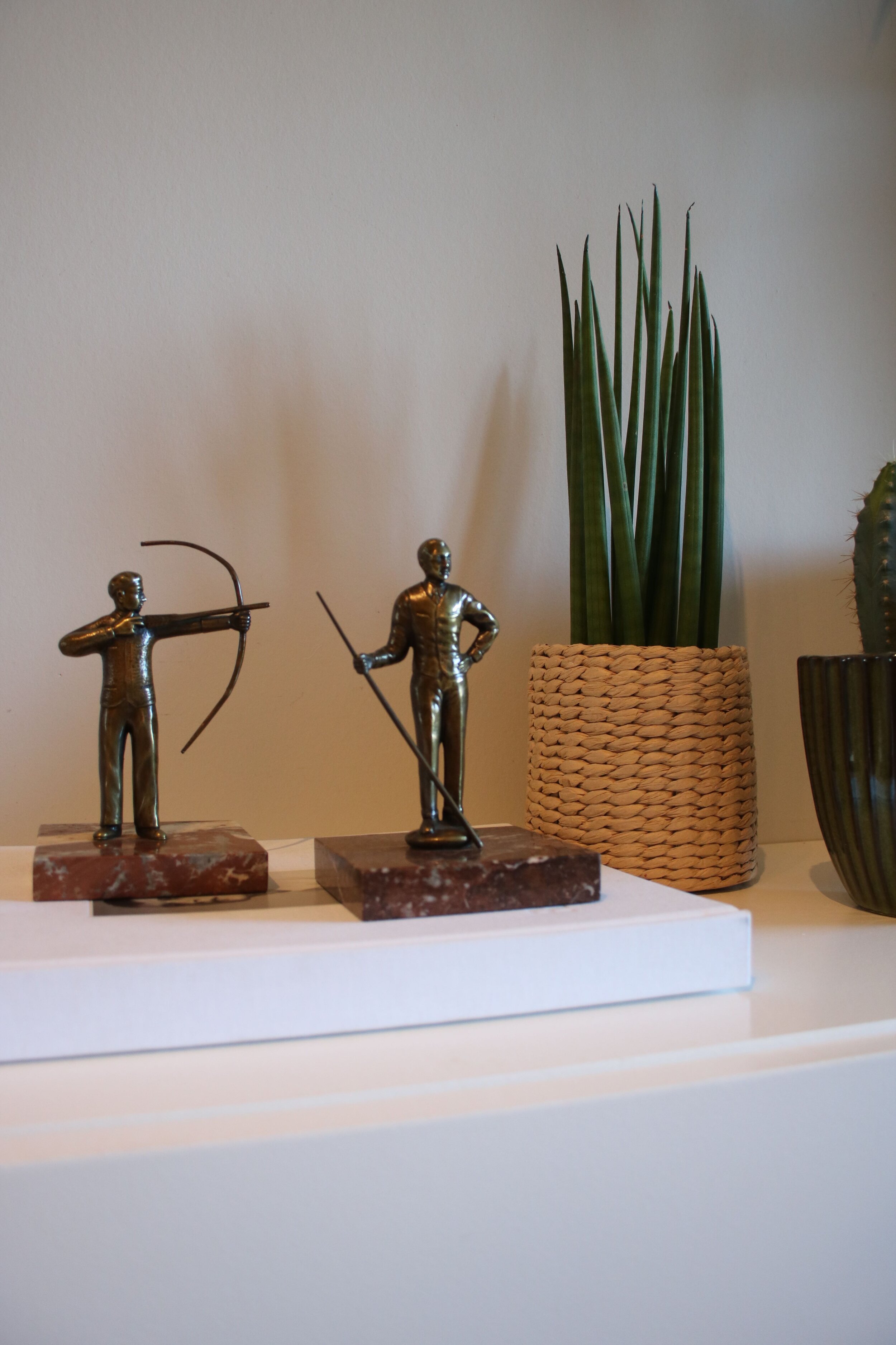 2 Bronze fellas on a piece of marble