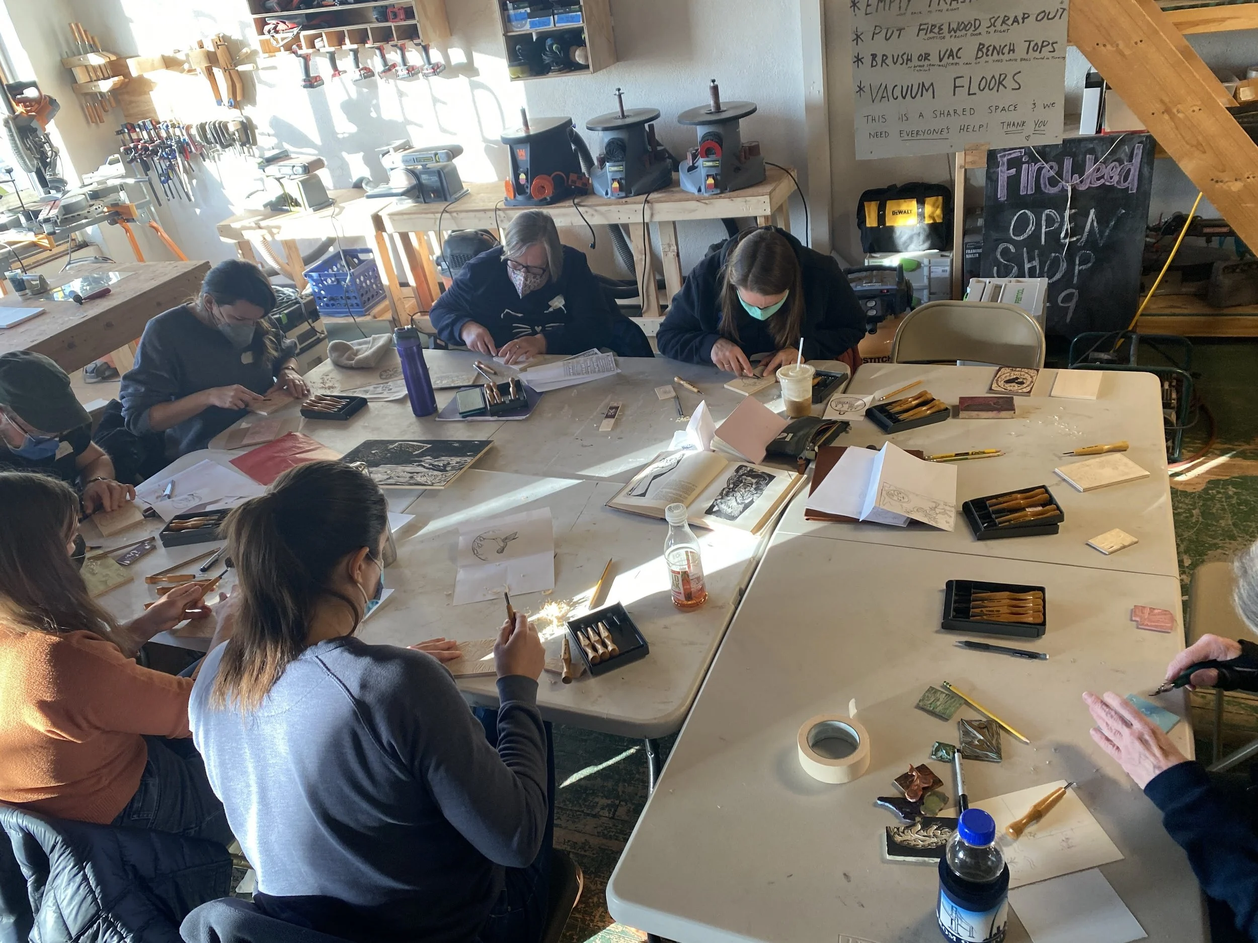 Students carving at a Fireweed printmaking class