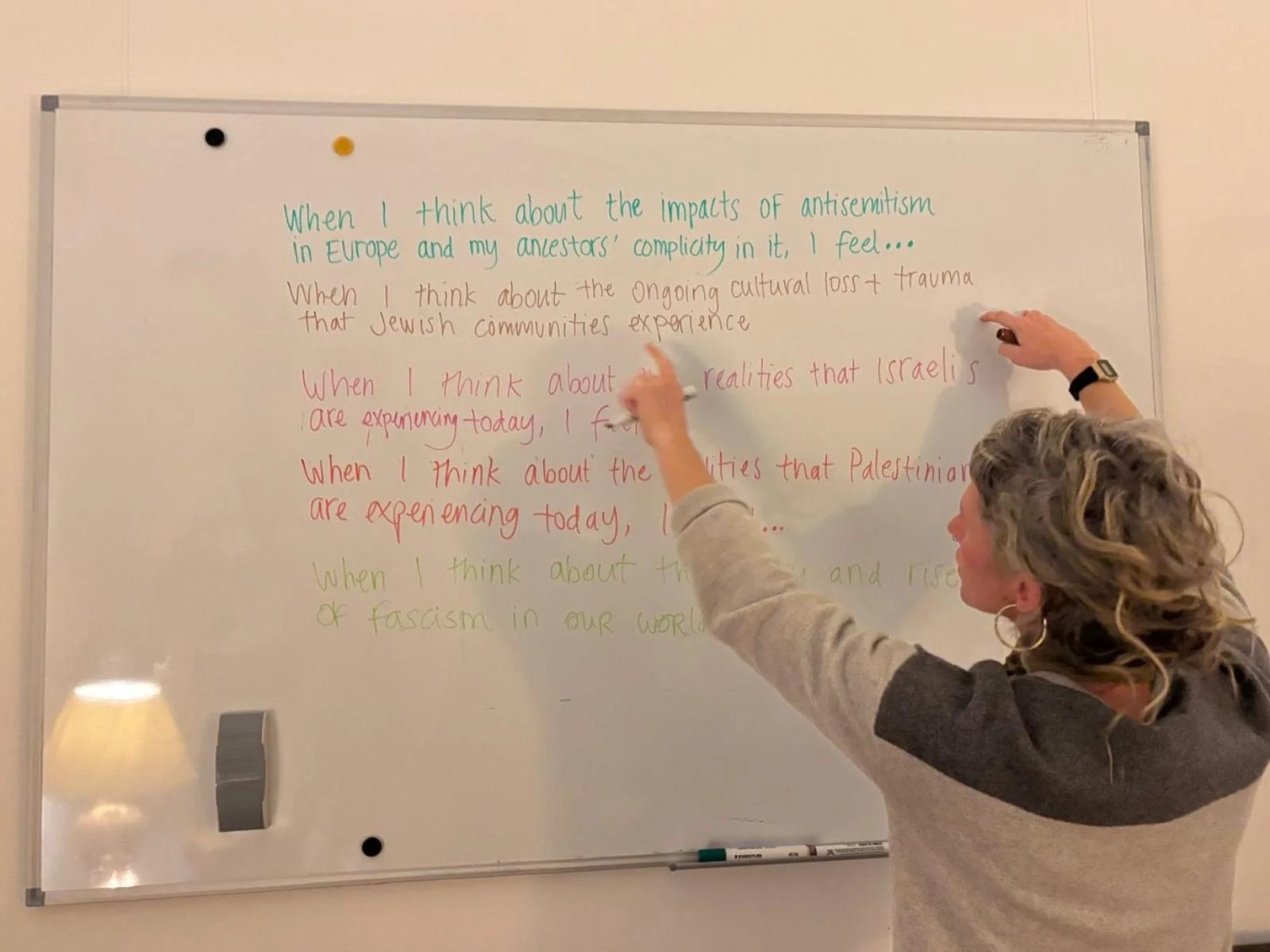 Woman writing on whiteboard