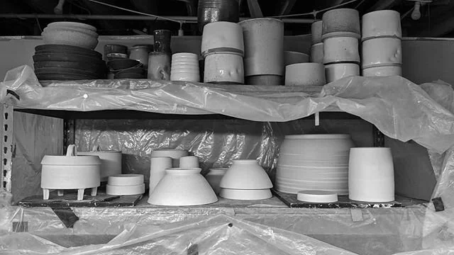 #shelfie , May version. Root cellars, mixing bowls, ramen bowls, one big planter, a couple of fermenters all drying slowly on the bottom. Some stacks of nice planters, some ok bowls and whole bunch of failed/mostly failed experiments on the top shelf