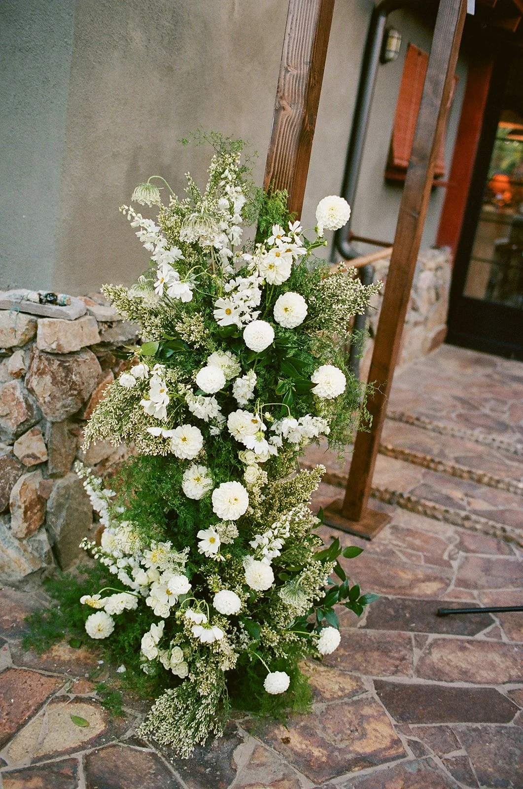 Close up of florals at base of chuppah