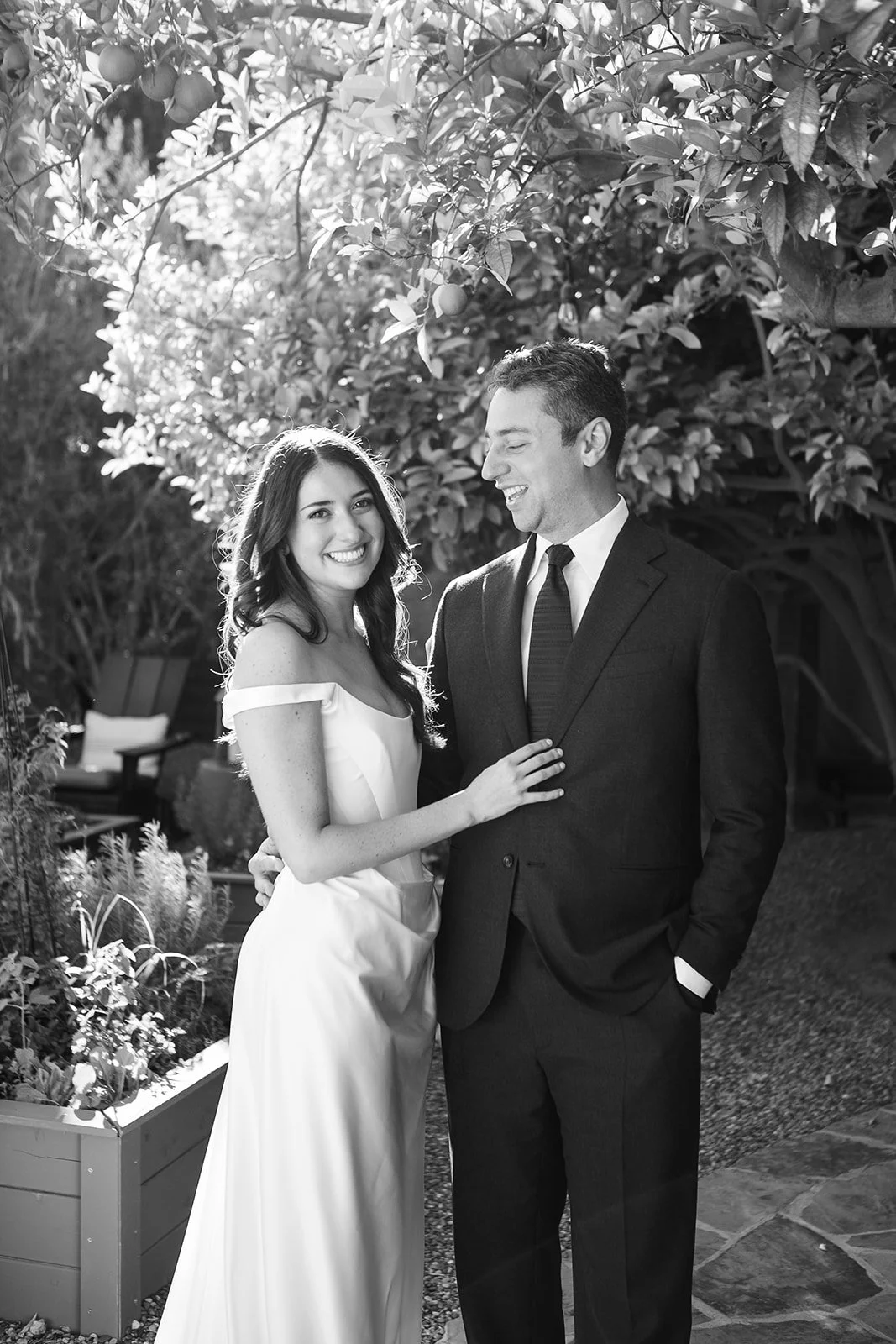 Bride and groom smiling together in an embrace