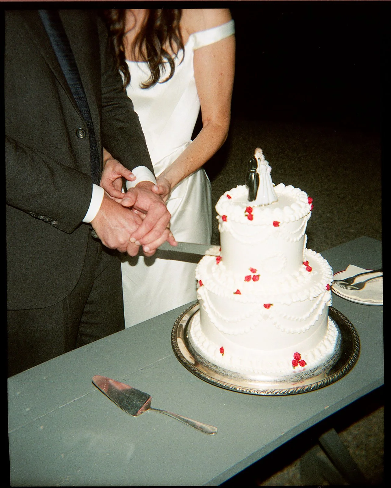 Bride and groom cutting cake together