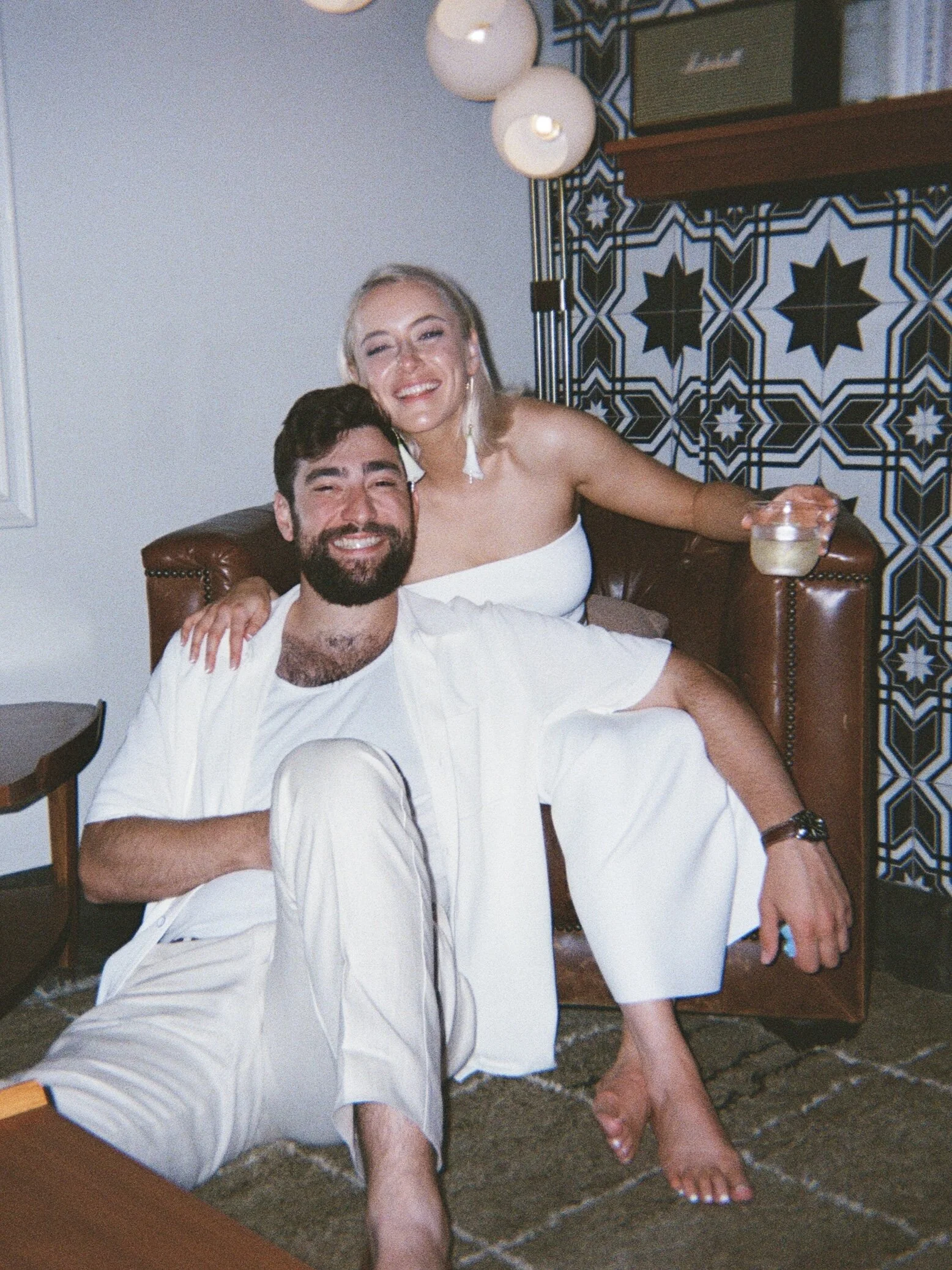 Bride and groom dressed in white smiling together