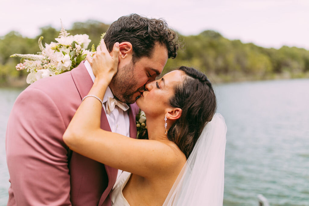Newly weds share a kiss during their portraits