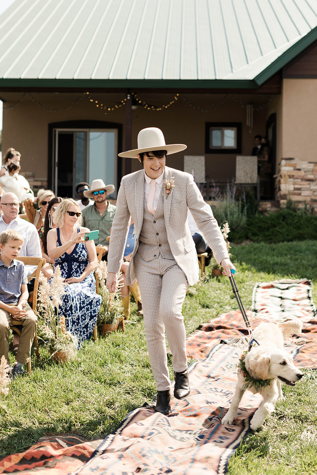 Best Man walking the newly weds pup down the aisle