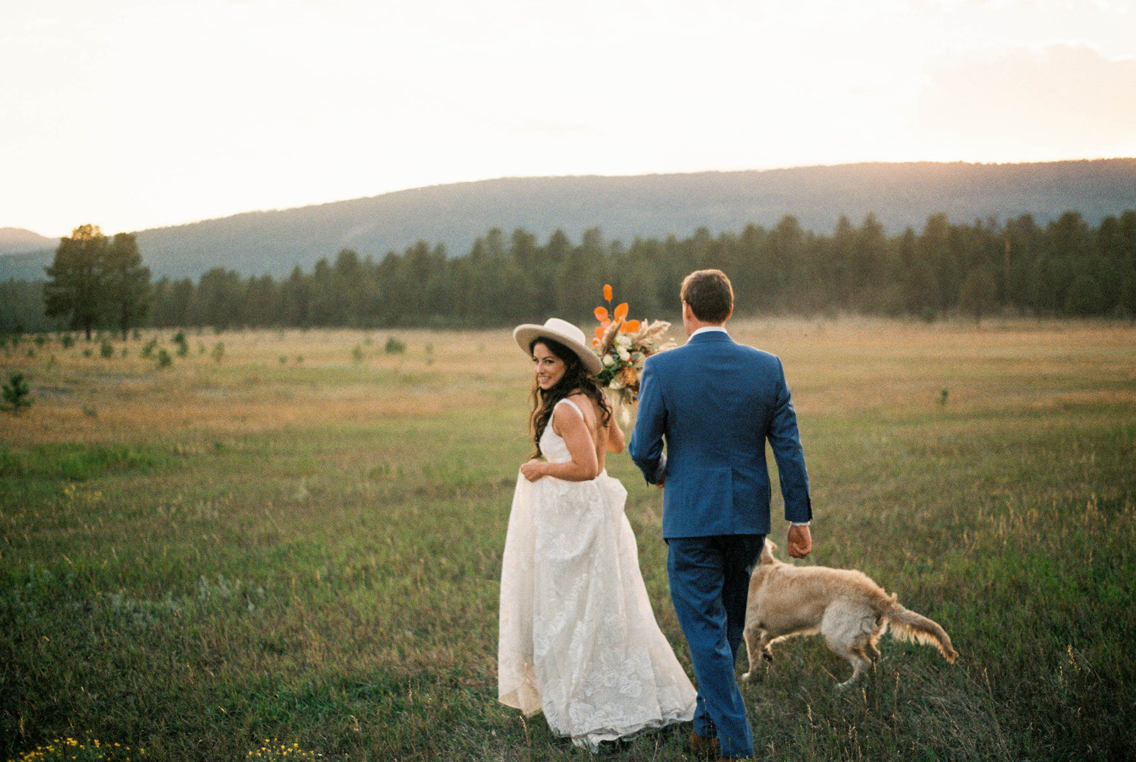 Boho Western Newly Weds with their Pup at sunset