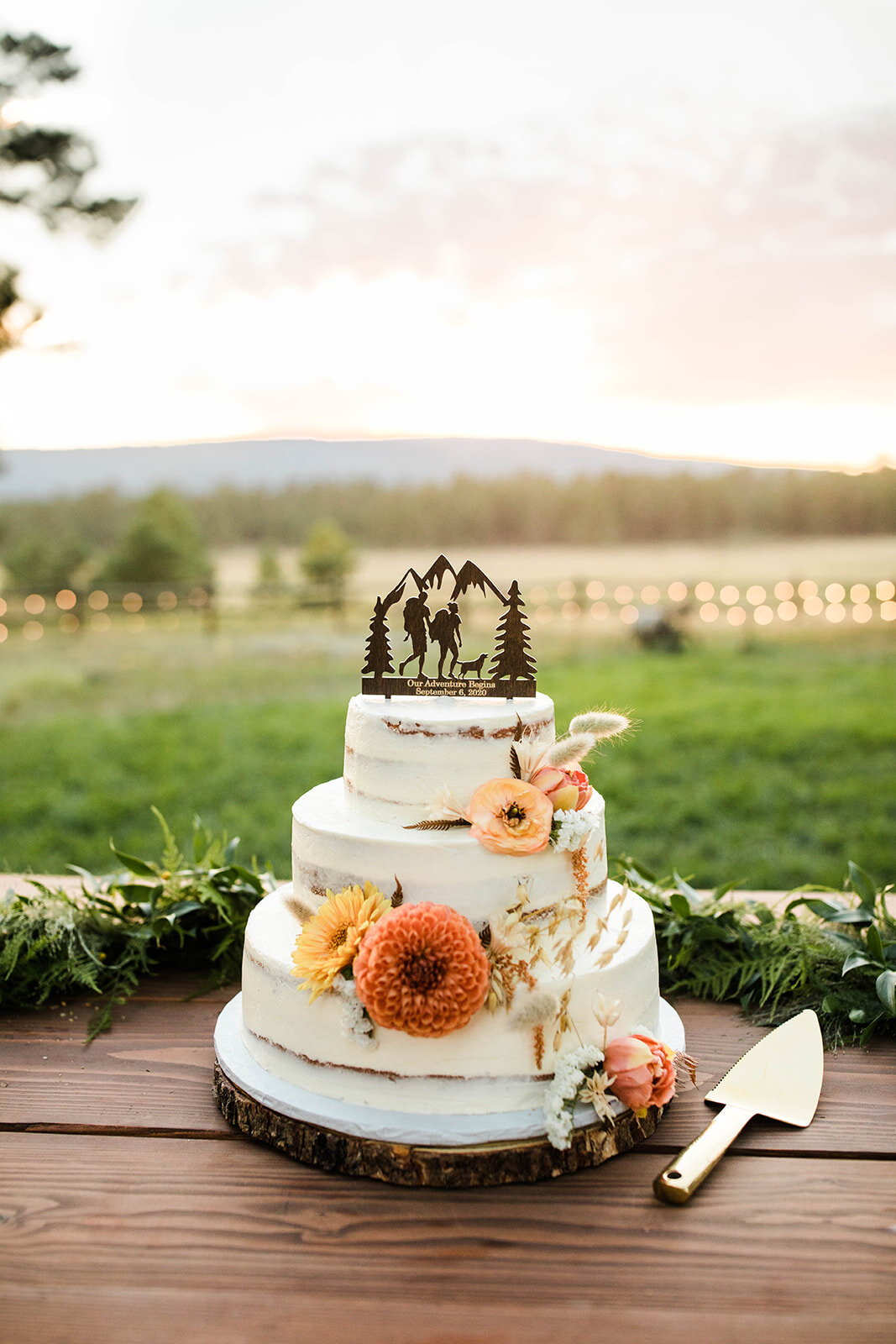 Rustic Boho Wedding Cake with an Adventurous Cake Topper