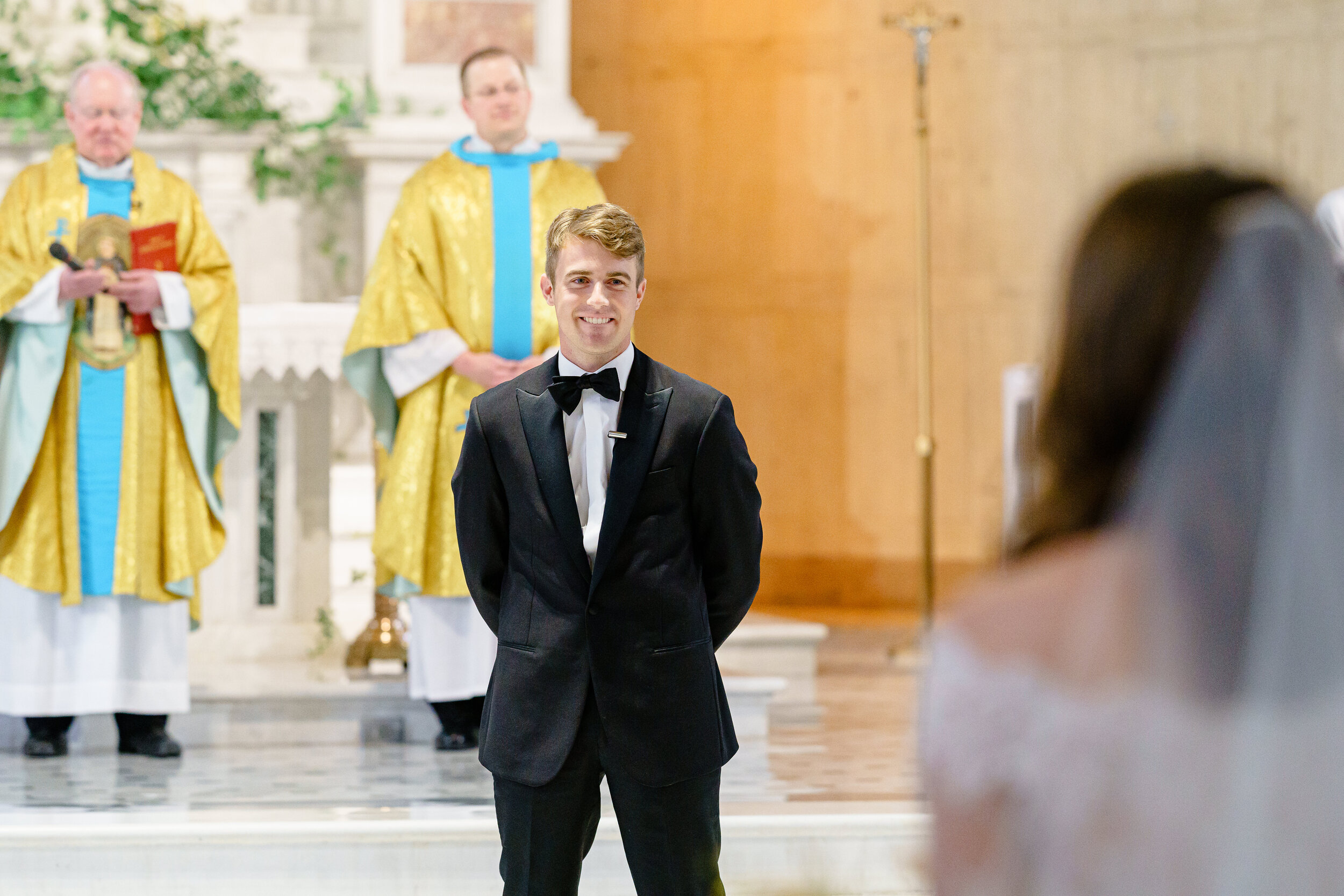 Classic groom seeing his elegant bride walk down the aisle