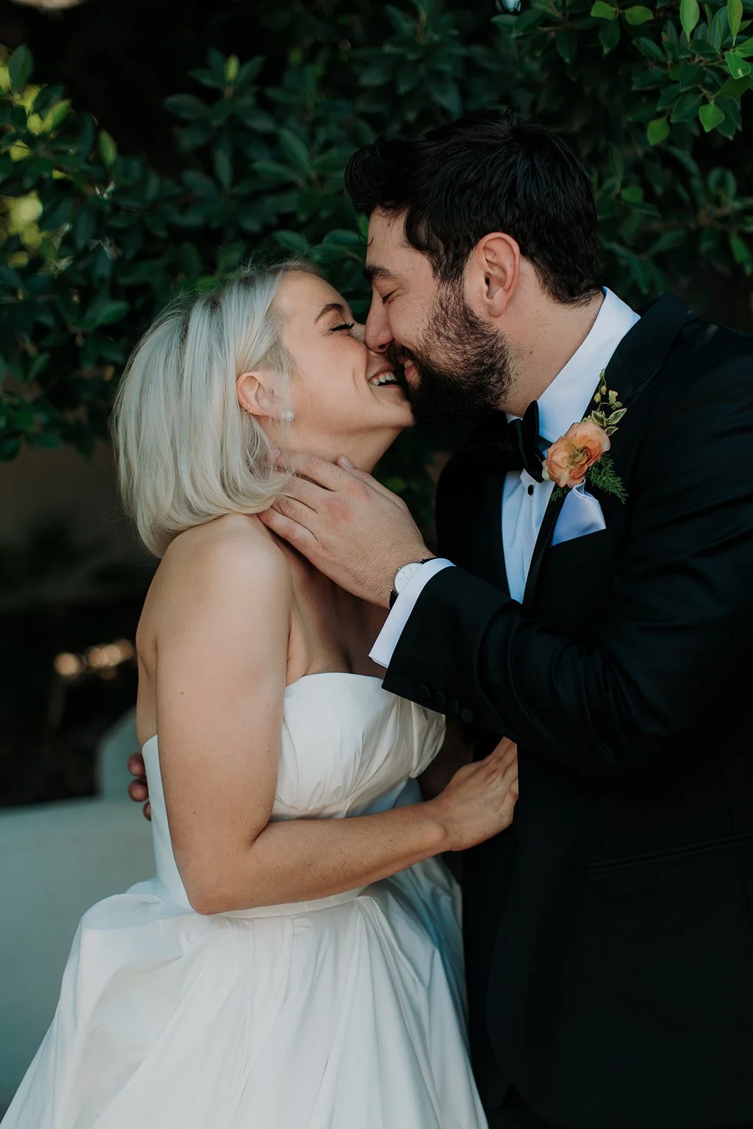 Bride and groom kissing in wedding attire