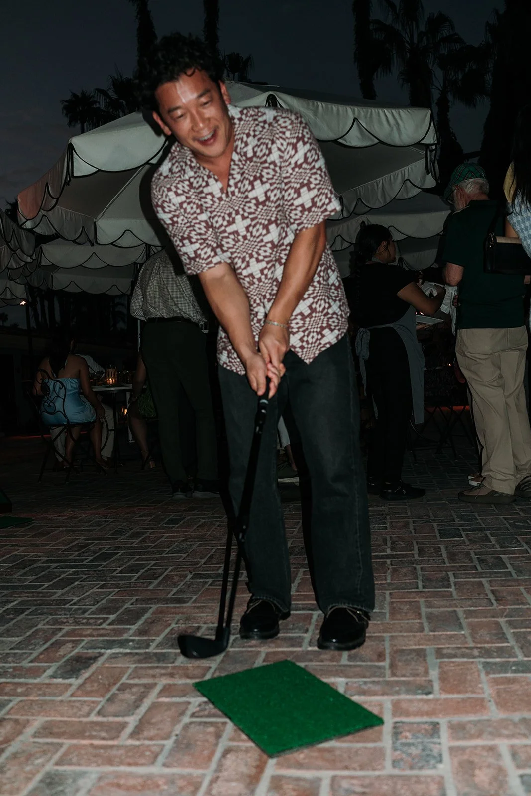 Guest playing mini golf game