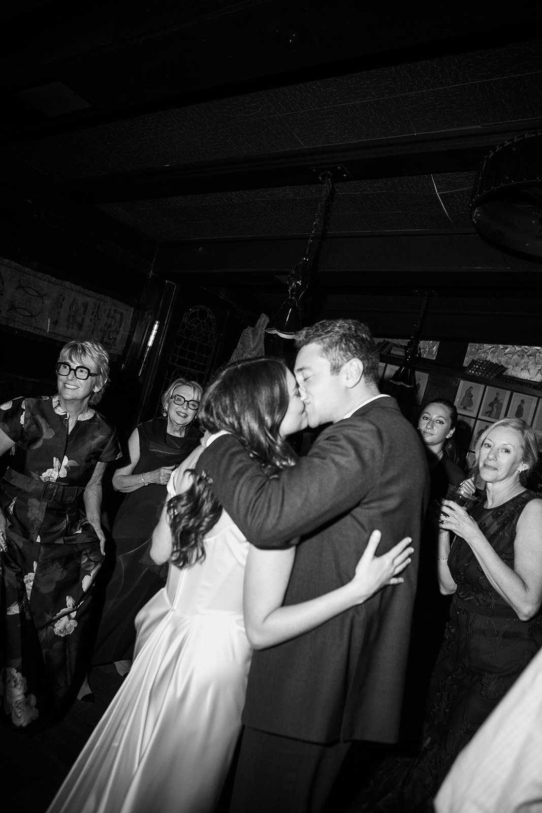 Bride and groom kissing on dance floor