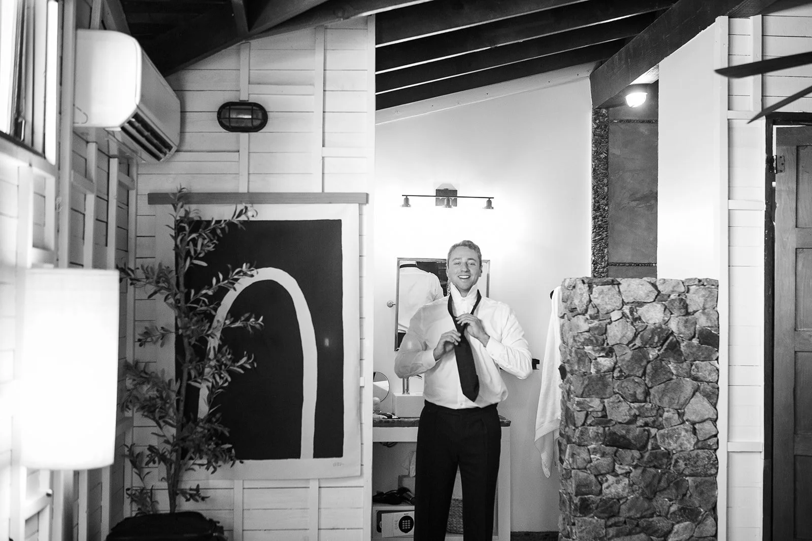 Groom adjusting his tie