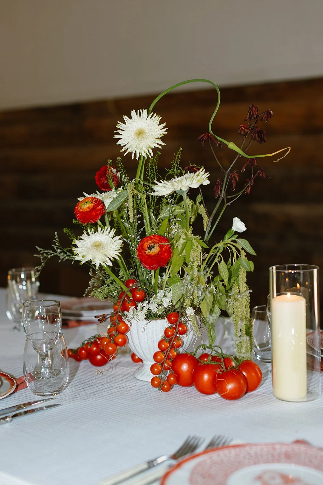 Tomato and greenery floral arrangement on table