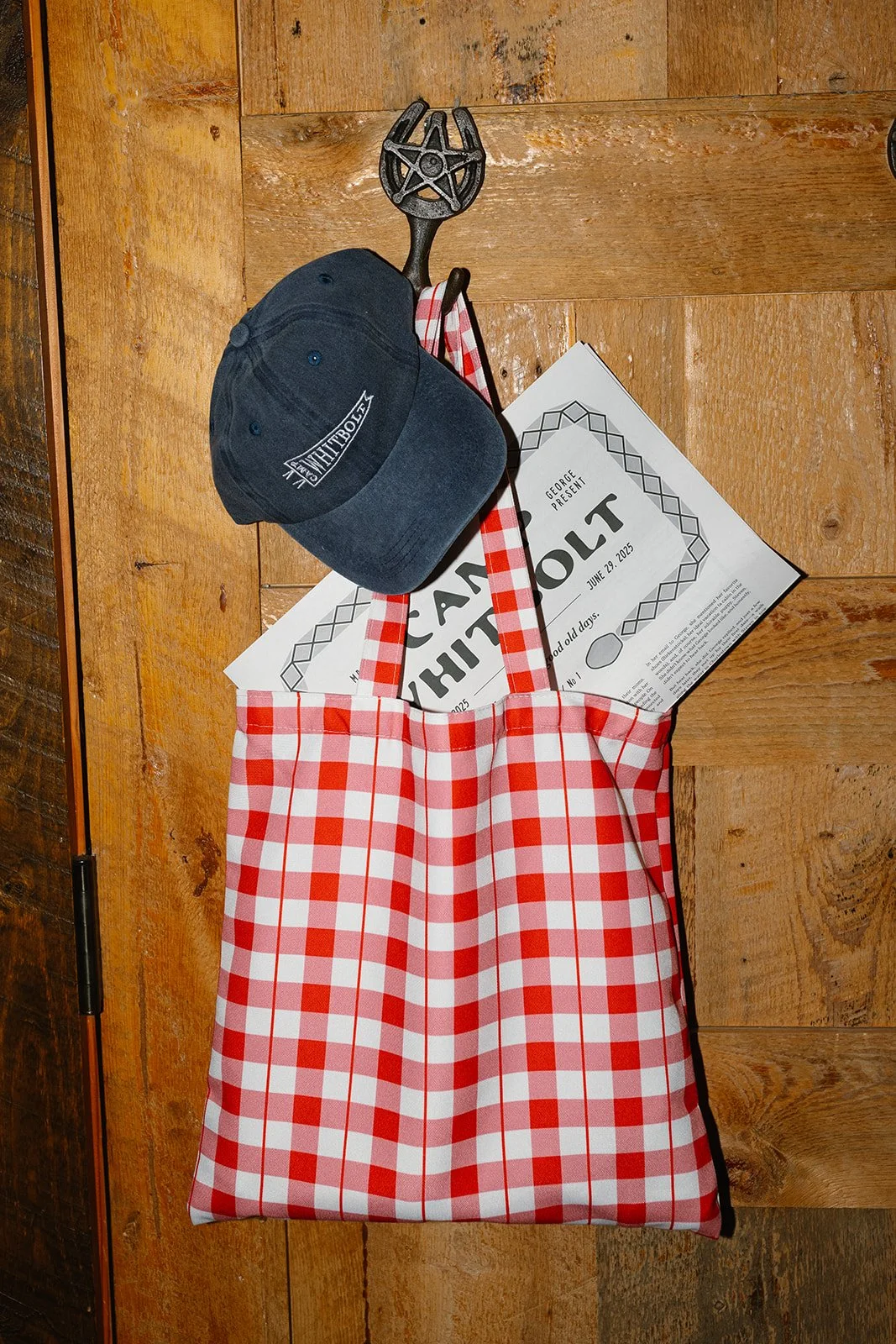 Welcome bag with custom hat and newspaper hanging up