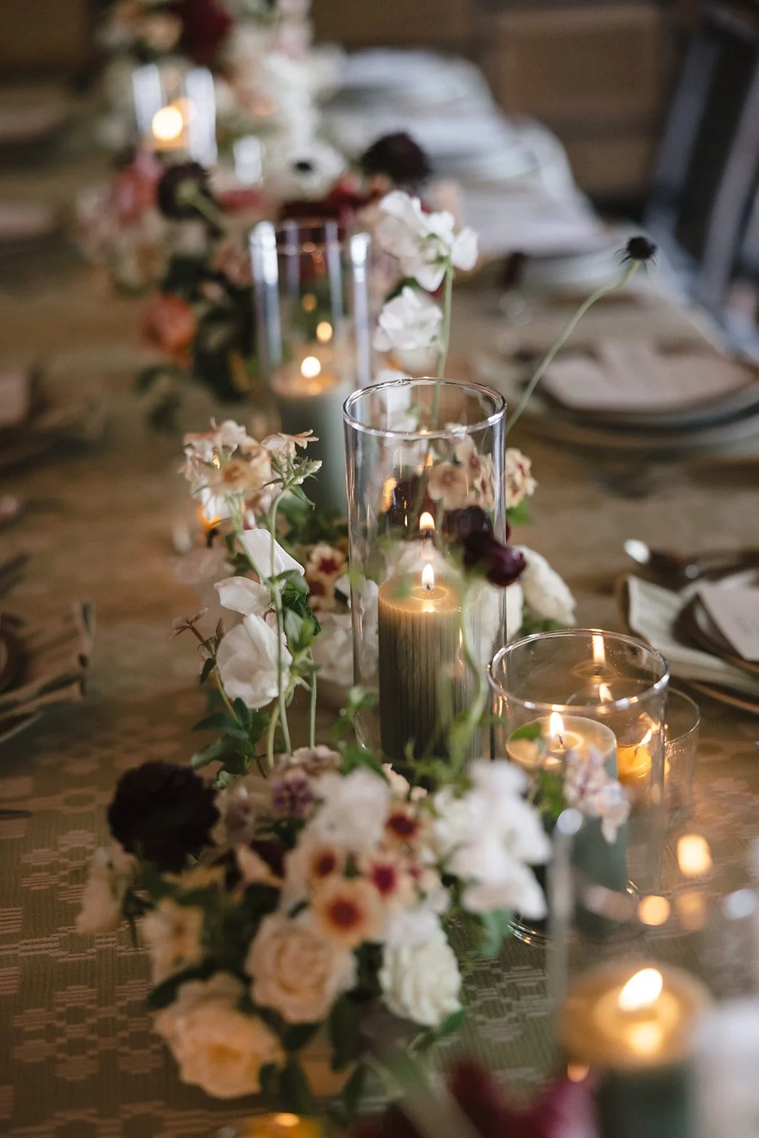 White, red and green florals at wedding dinner