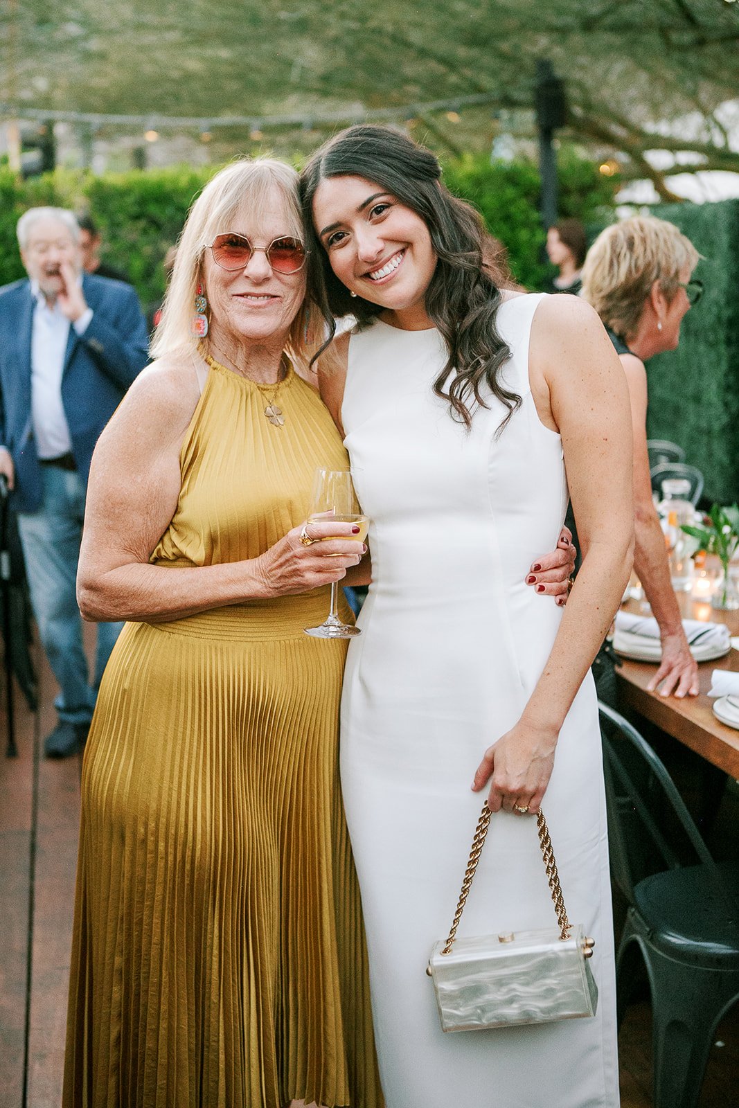 Bride hugging guest at welcome party