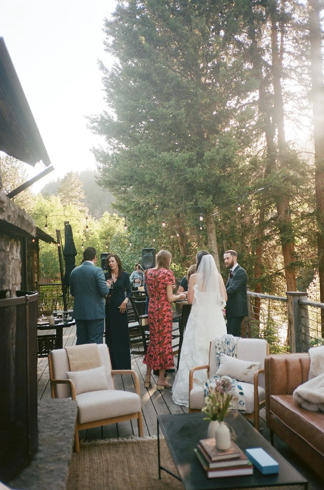 Wedding guests standing outside on porch with band playing