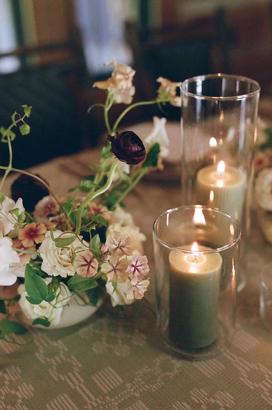 Floral arrangement with candle on reception table