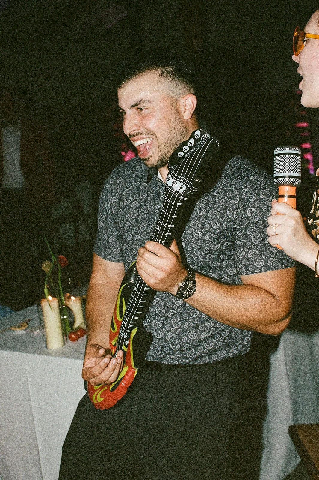 Wedding guest playing in flatable guitar