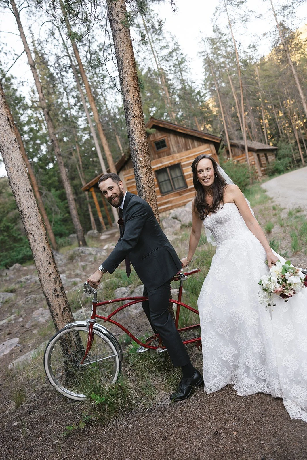 Bride and groom riding a tandem bike in Colorado