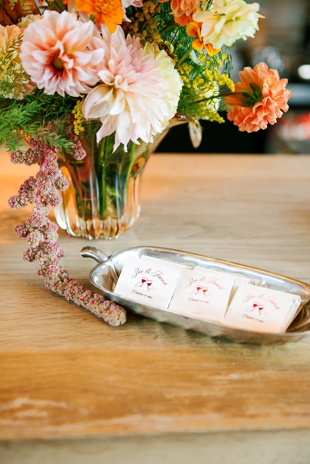 Custom matches with bride and groom names next to floral arrangement