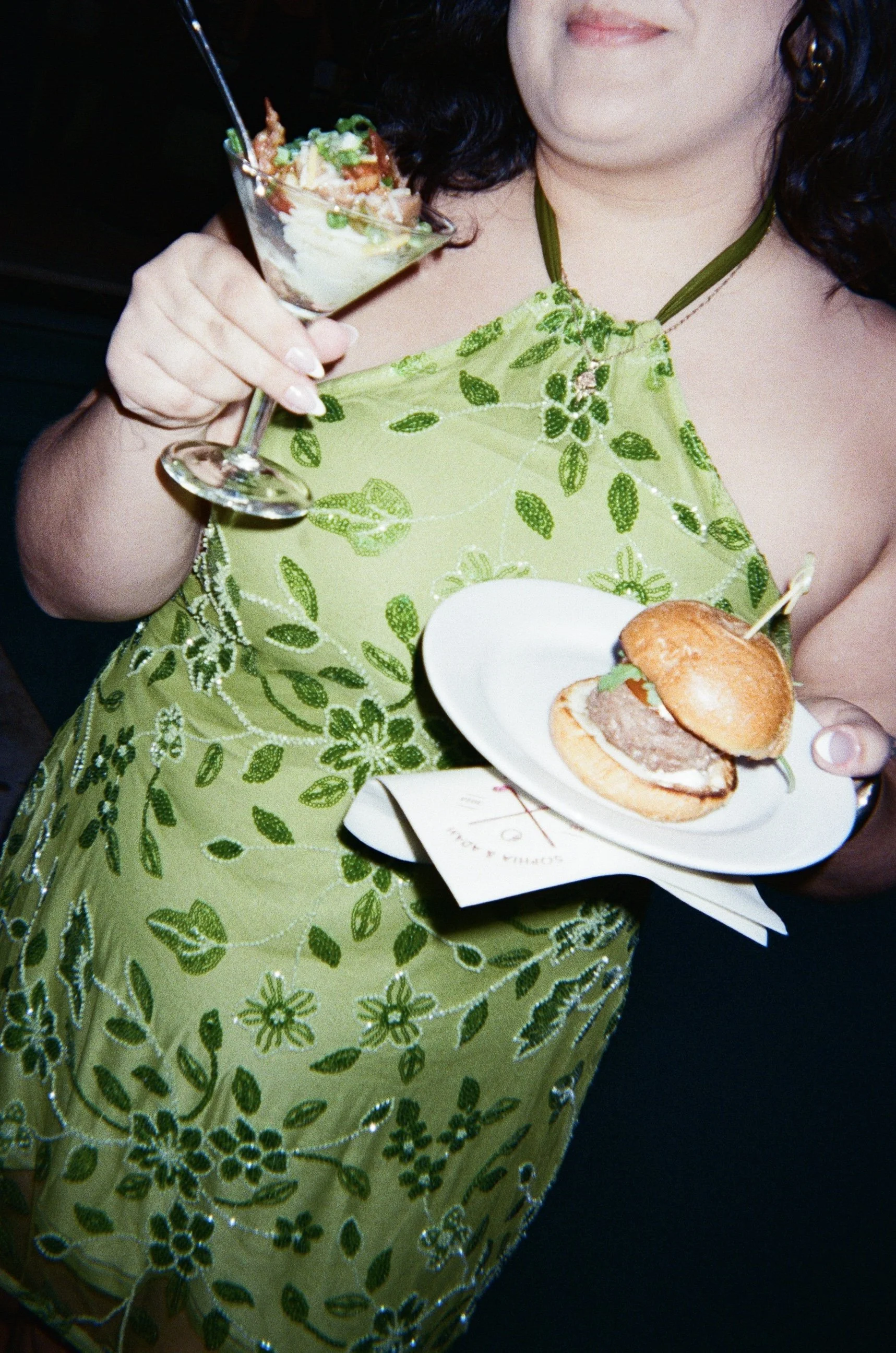 Guest enjoying slider and mashed potato martini at welcome party