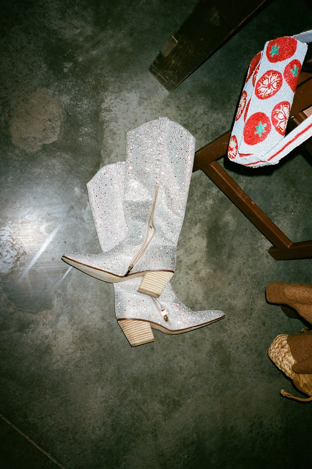 Sparkly cowgirl boots laying on the ground