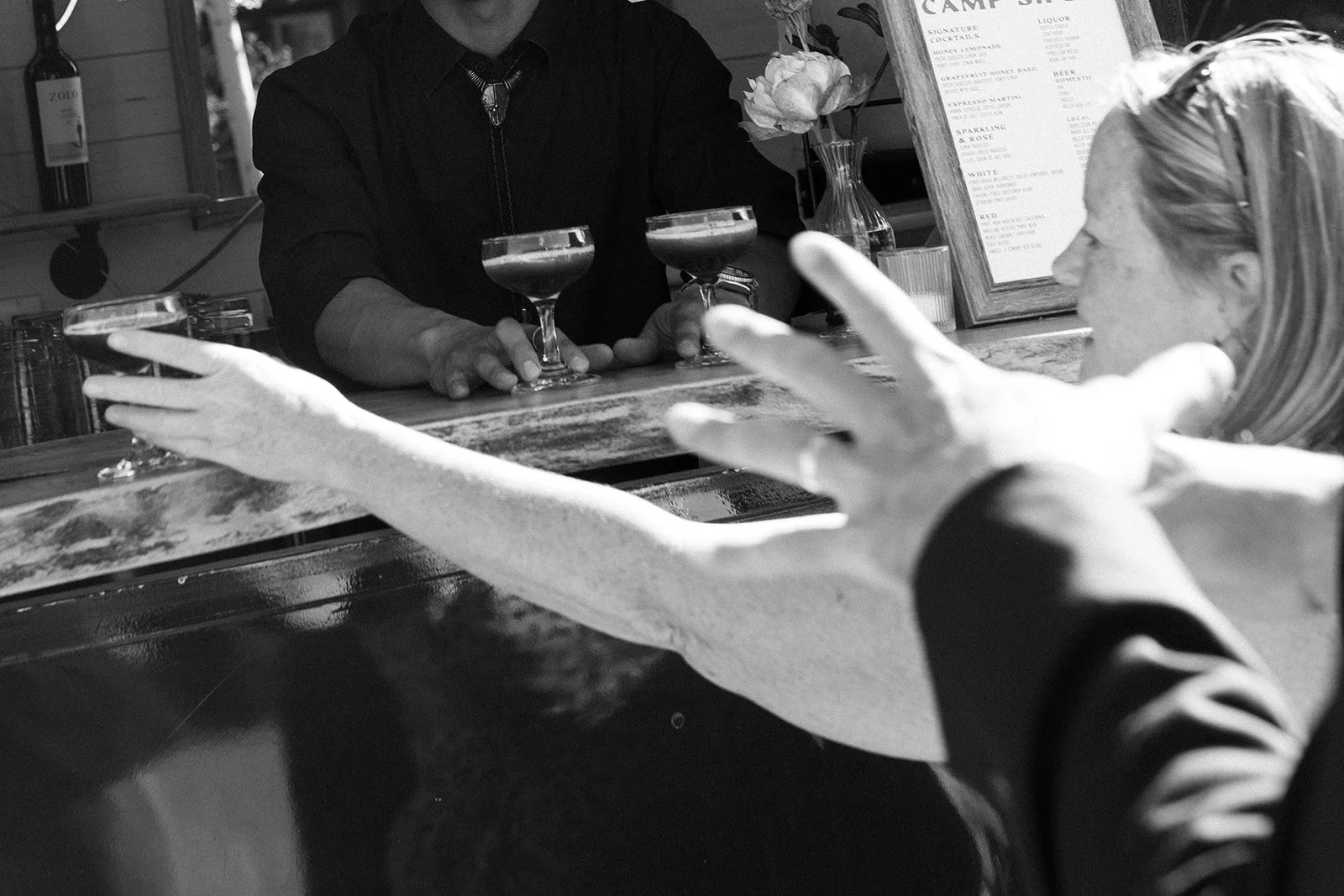 Guests reaching for cocktails at reception