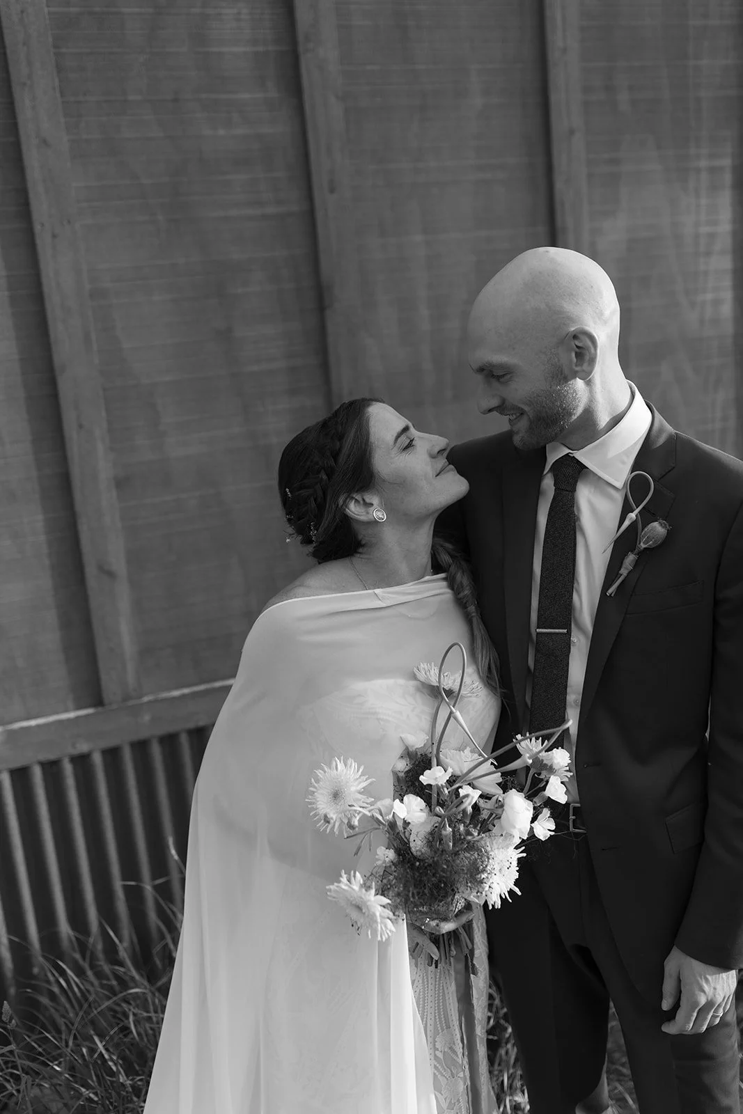 Bride and groom embraced smiling at each other
