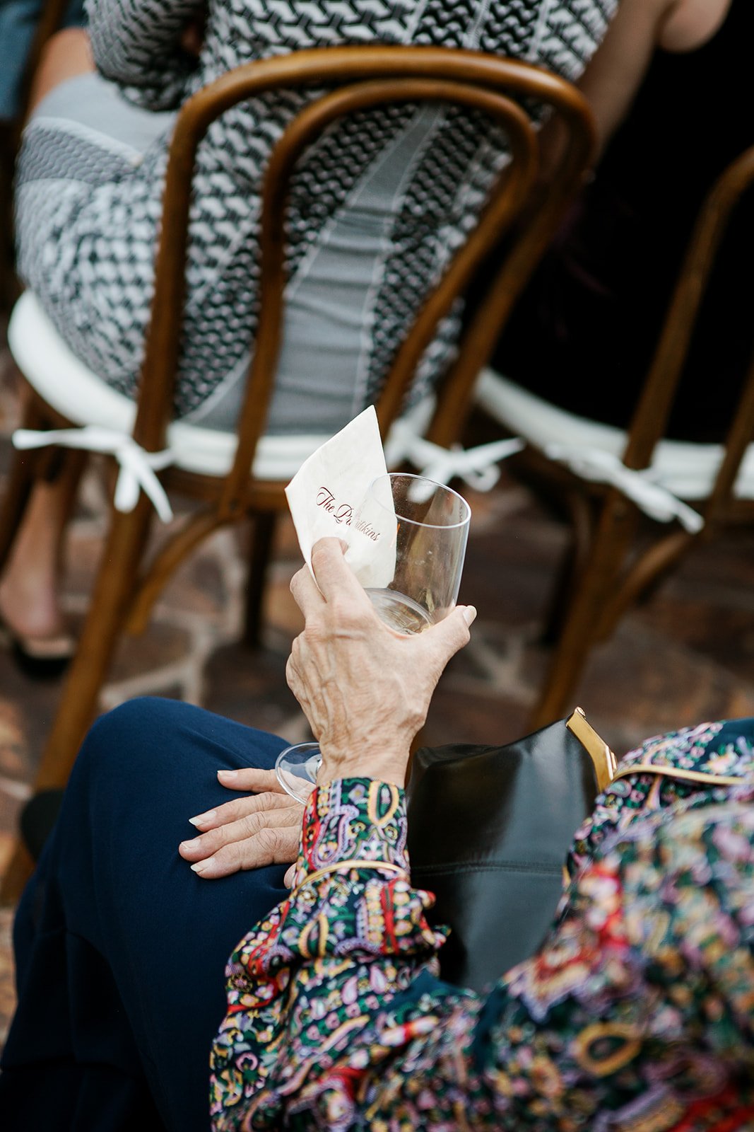 Guest holding drink during ceremony