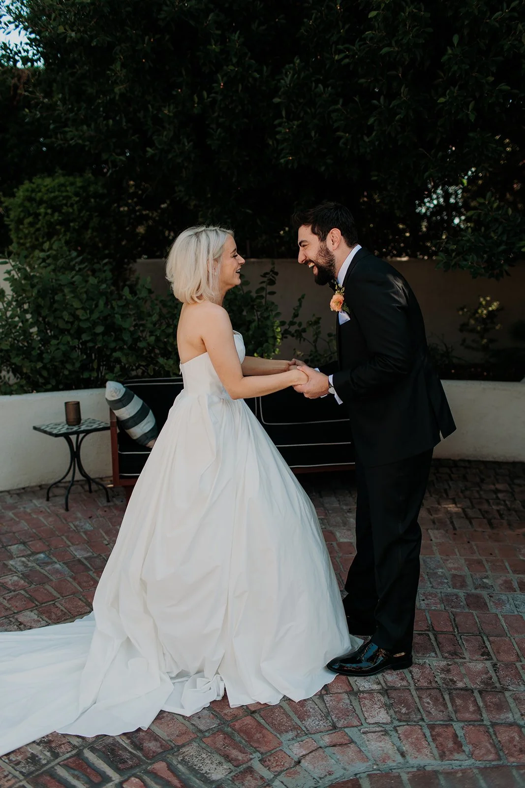 Bride and groom first look holding hands