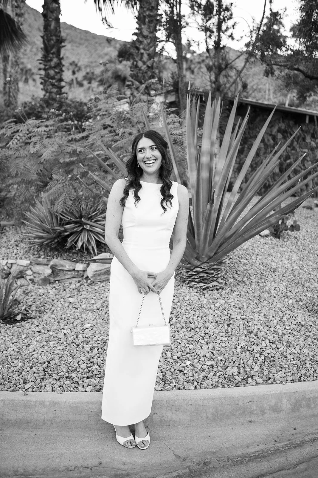 Bride smiling at camera in front of cacti