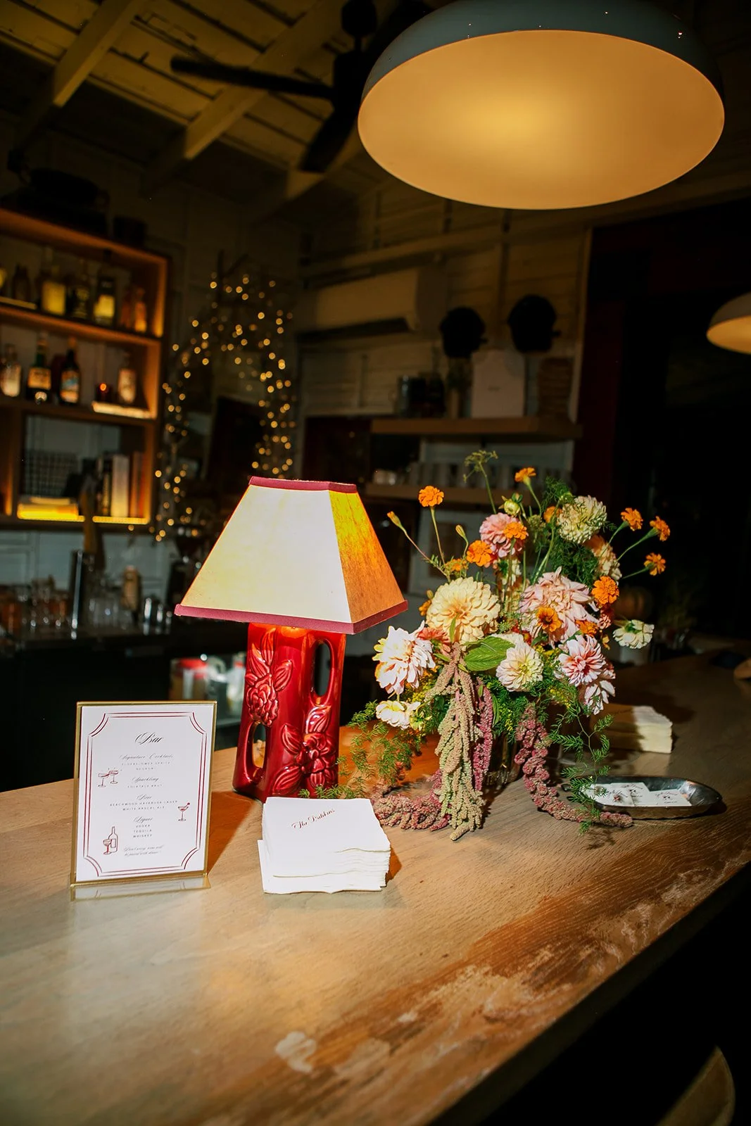 Bar with florals, custom napkins and drink menu