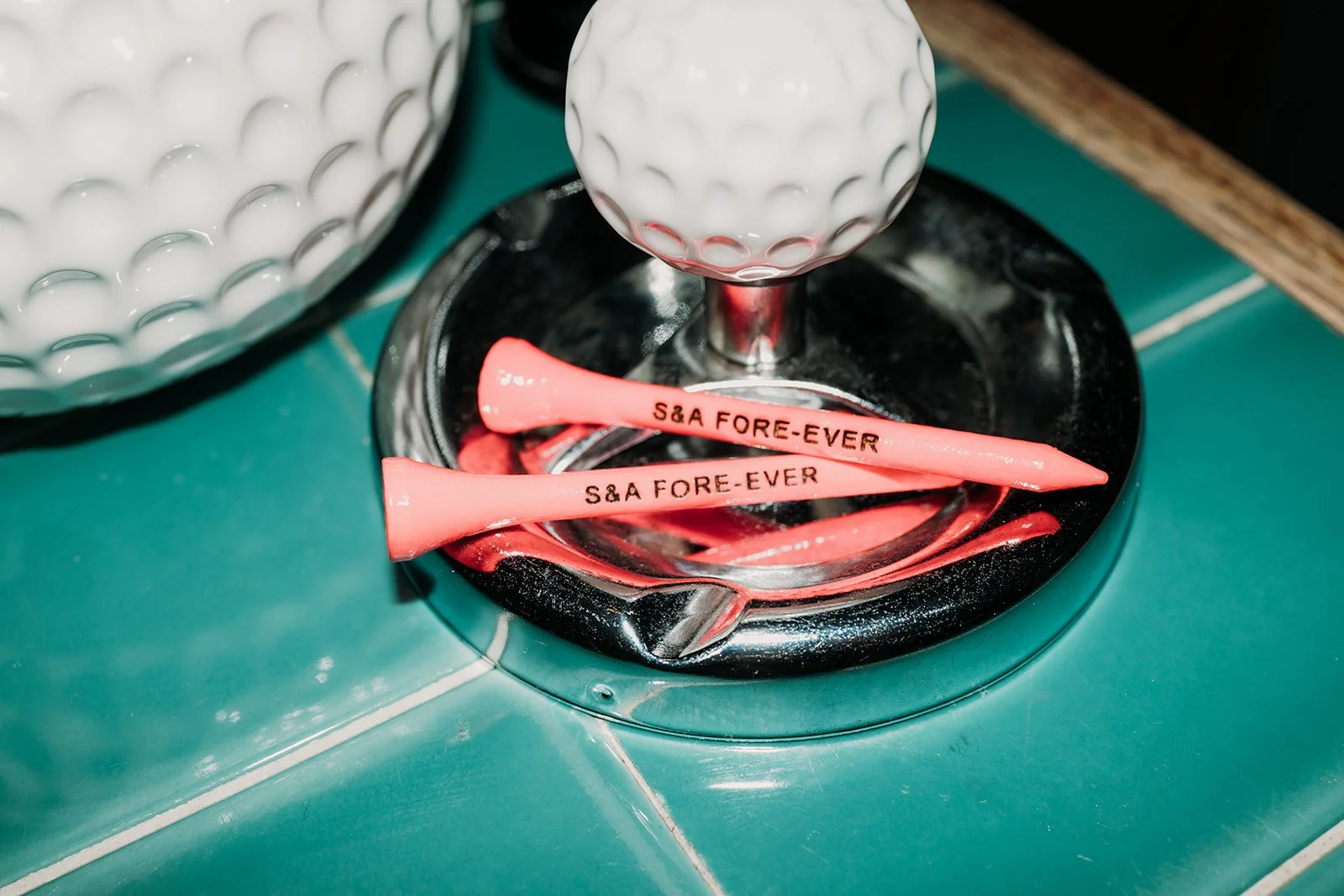 Custom golf tees on golf ball ashtray