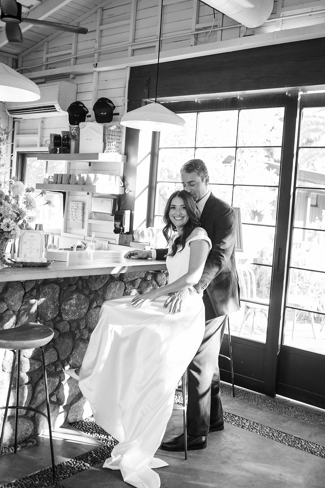 Bride and groom sitting at bar together
