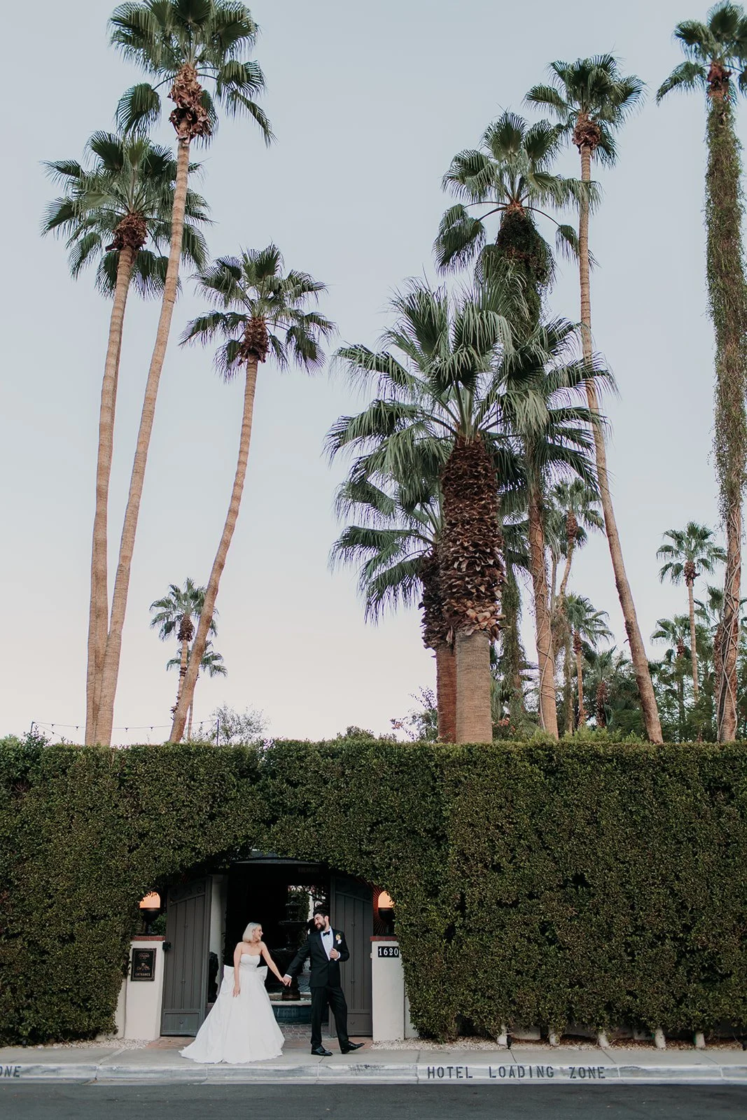 Bride and groom holding hands walking to reception