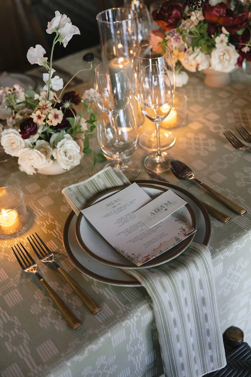 Place setting at dinner table with napkin falling over end of table