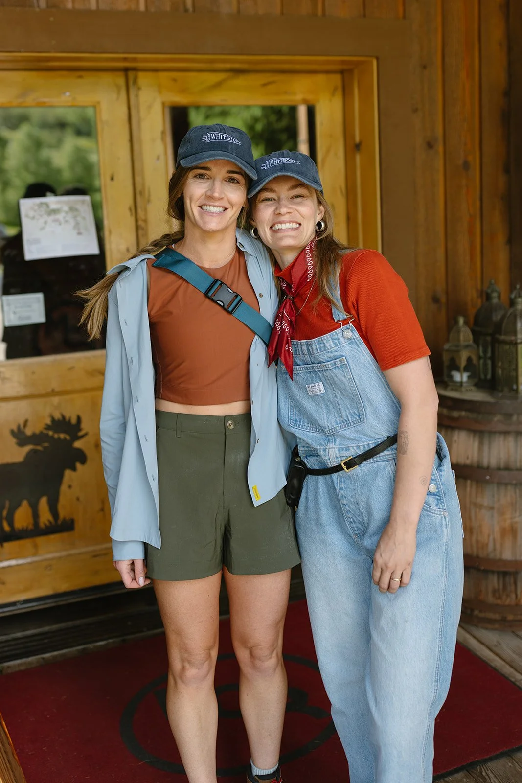 Wedding planner and guests in front of cabin